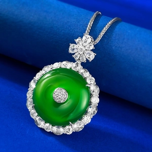 Détail macro d'un pendentif en pierre vert émeraude avec accents de fleurs diamants