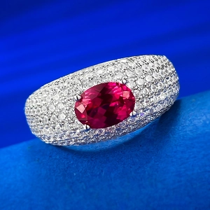 Elegant silver ring with a large oval ruby centerpiece and pave zircon accents on band