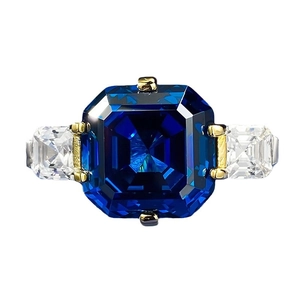 Three-stone ring featuring a royal blue Asscher cut sapphire and side baguette zircons