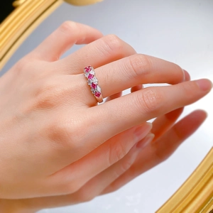 Close-up of S925 silver ring with alternating red rubies and clear zircon stones