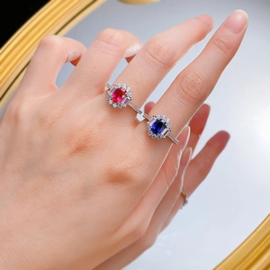 Detail of luxury S925 silver ring featuring an oval sapphire and sparkling diamond halo