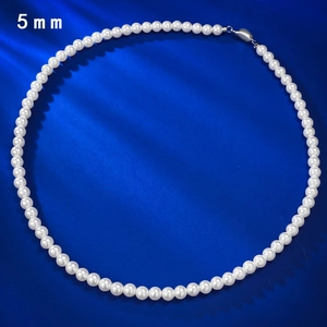 Elegant 5mm round pearl necklace with silver clasp on a blue satin background
