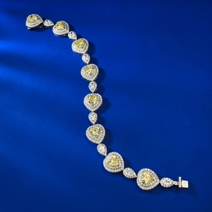 Luxury heart-shaped yellow gemstone bracelet with sparkling diamond halo in silver