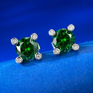 Macro view of 925 sterling silver stud earrings with 1ct green sapphire and diamond halo