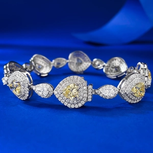 Macro shot of S925 silver bracelet featuring heart-shaped yellow diamonds and blue background