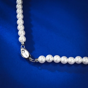 Macro shot of S925 sterling silver clasp and white pearls on a high-end necklace