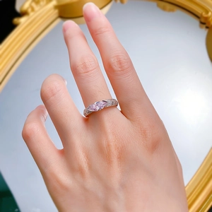 Close-up of marquise pink diamond ring with pave setting on white gold band