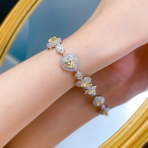 Detailed view of S925 silver bracelet featuring heart-shaped yellow diamonds on wrist