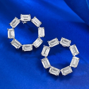 Elegant S925 silver hoop earrings with emerald cut cubic zirconia on blue silk background