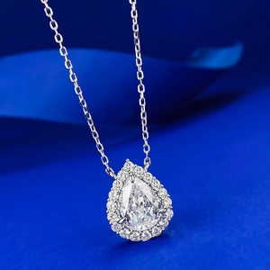 Elegant 8x10mm pear-cut carbon diamond drop necklace with silver pavé halo on blue background