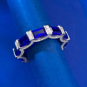 Macro shot of S925 silver wave band ring with rectangular royal blue gemstones