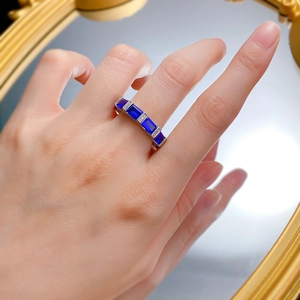 Macro detail of S925 silver ring featuring five rectangular blue sapphire stones on hand