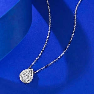 8x10mm pear cut drop pendant necklace with halo crystals on blue artistic background