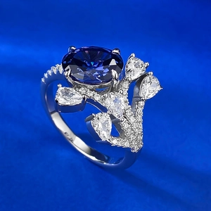 Detailed view of an oval blue gemstone ring with sparkling side waterdrop stones