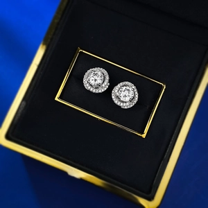 Vue macro de boucles d'oreilles halo en argent 925 dans un coffret cadeau luxueux