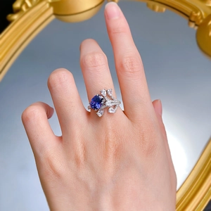 Close-up of S925 silver ring with oval tanzanite blue stone and droplet accent diamonds