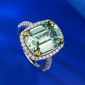 Macro shot of S925 silver stamp on emerald cut green gemstone ring with pavé diamonds