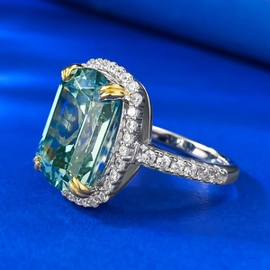 Macro shot of S925 silver ring featuring emerald cut green gemstone and micro-pave diamonds