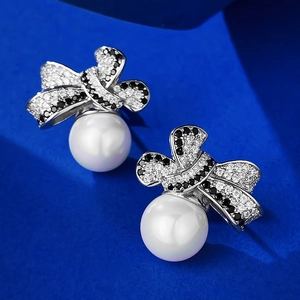 Elegant 925 silver bow stud earrings with 10mm white pearls and pave crystals