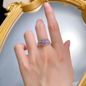 Detailed close-up of a square purple gemstone ring with radiant micro-paved diamond setting