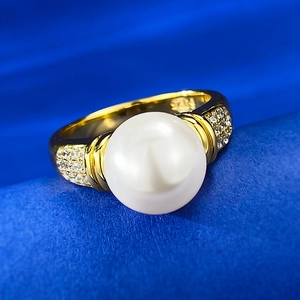 Close-up of S925 silver hallmark and pave crystals on a gold pearl ring band