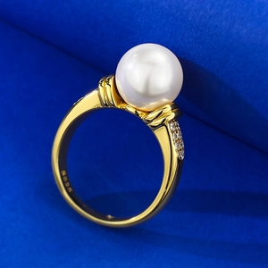 Detail of S925 silver pearl ring featuring 10mm white bead and fine pavé side diamonds
