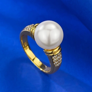 Elegant 10mm white pearl ring with gold metal and zircon accents on blue silk background