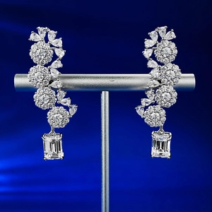 Detailed macro of S925 silver floral earrings featuring emerald-cut zircon pendants