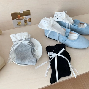 Detail of ruffle lace bow socks in polka dot, black and grey with blue Mary Jane shoes