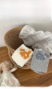 Detailed view of combed cotton socks featuring 3D fluffy balls and cute cartoon cat patterns