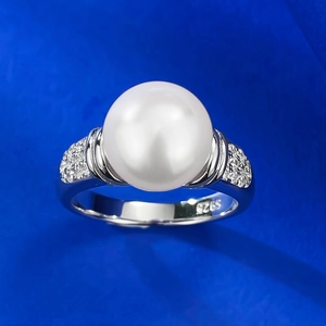 Macro view of S925 sterling silver stamp and 10mm pearl setting on geometric ring