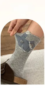 Detail of grey cat crew socks showing high elasticity and cute 3D plush ball cat ears