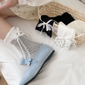 Close-up of sweet lolita lace socks with ribbon bows in grey, white, and black colors