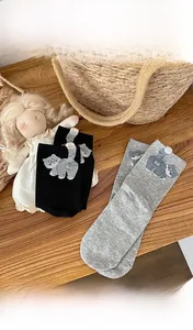 Detail of cotton socks with 3D plush ball cat tail and cute cartoon embroidery