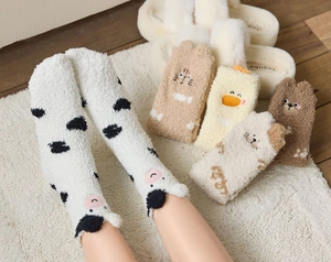 Close-up of soft coral fleece socks featuring cute 3D animal embroidery and ears