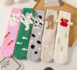Detail of five pairs of thick coral fleece thermal socks with 3D cartoon animal patterns