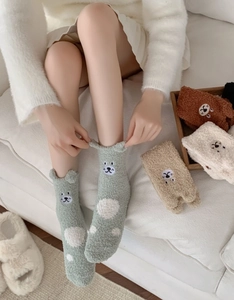 Detailed view of soft coral fleece socks with 3D ears and cartoon embroidery for winter