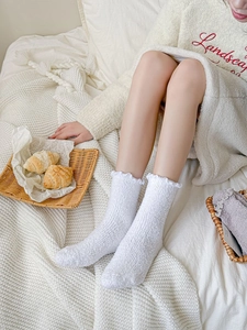 Detalle de calcetines de forro polar coral blanco suave con bordes de volantes