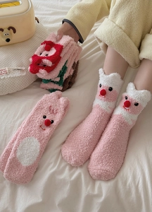 Detailed close-up of fuzzy coral fleece pink socks with 3D cute cartoon beaver design
