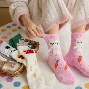 Detail of coral fleece thick warm socks featuring colorful cartoon animal patterns