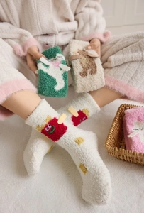 Detail of plush coral fleece socks featuring cute 3D cartoon designs for winter comfort