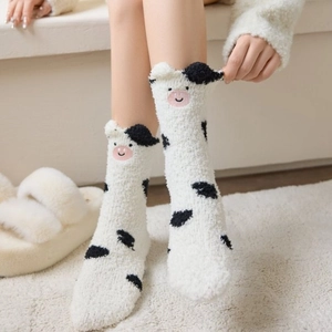 Detail of coral fleece cow print socks with 3D ears and cute embroidery for winter