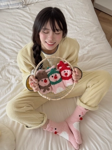 Detail of coral fleece socks with cute 3D red nose beaver embroidery and warm texture