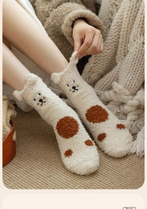 Dettaglio ravvicinato di calze spesse in pile corallo beige con orsetto e orecchie 3D