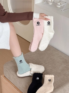 Detail of coral fleece socks with 3D flower embroidery and decorative pearl accents