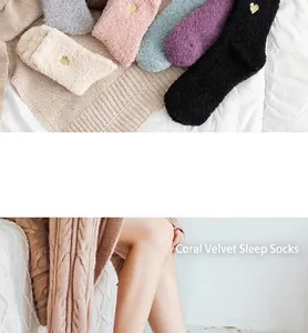 Close-up of soft coral fleece socks with gold heart embroidery and fluffy warm texture
