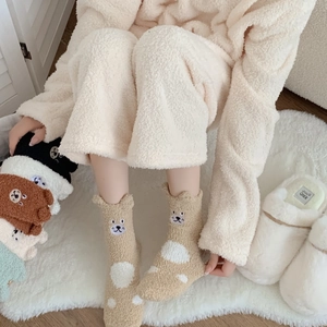 Close-up of thick coral fleece winter socks with 3D ears and cute cartoon bear embroidery