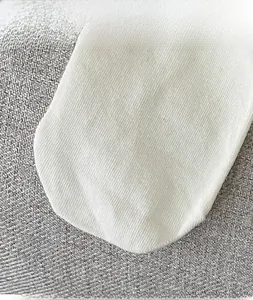 Close-up of white combed cotton socks with elastic ribbed cuffs and anti-slip texture
