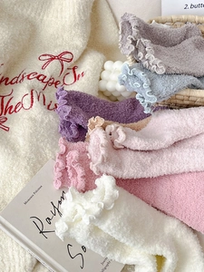 Primer plano de calcetines de coral fleece de colores con bordes de volantes suaves