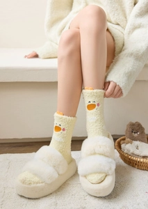 Detailed view of warm yellow coral fleece socks with cute cartoon duck face embroidery